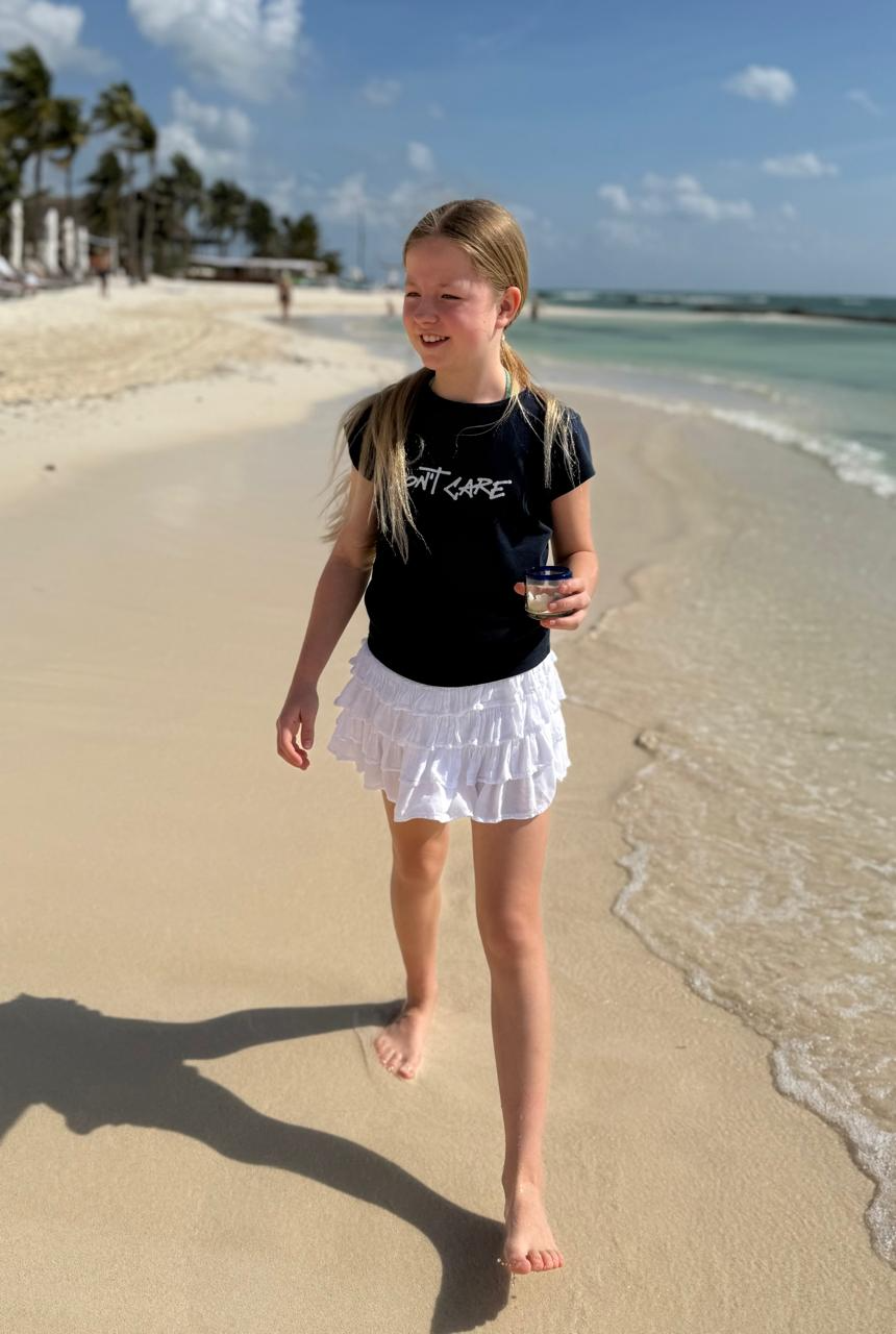 Aimee walking along a beach, smiling