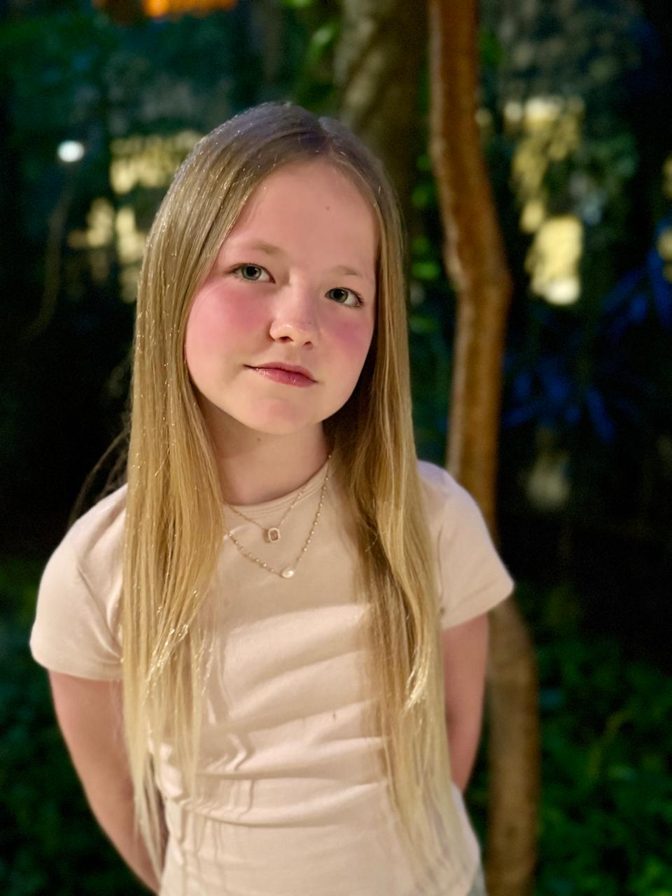 Aimee looking at the camera outdoors in the evening