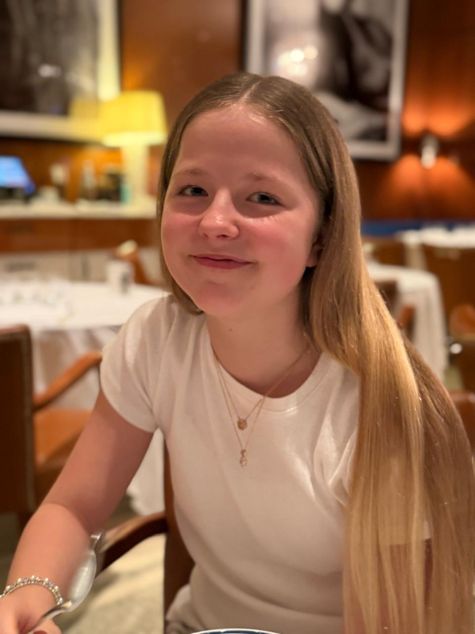 Aimee smiling at a restaurant table