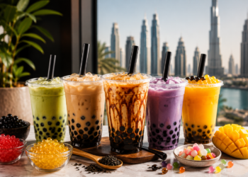 Colourful bubble tea drinks with tapioca pearls, fruit flavours and brown sugar milk tea overlooking the Dubai skyline – featured image for the Best Boba & Bubble Tea Places in Dubai 2026 guide.