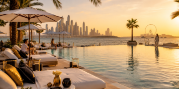 A premium Dubai beach club scene with sunbeds, pool, mocktails, towels, palm trees, sea views and warm golden sunlight.