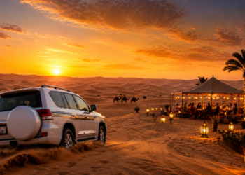 A premium Dubai desert safari scene with golden dunes, luxury camp lights, a 4x4 vehicle, camel silhouettes and sunset sky.