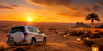 A premium Dubai desert safari scene with golden dunes, luxury camp lights, a 4x4 vehicle, camel silhouettes and sunset sky.