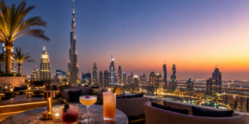 A premium Dubai rooftop bar scene with elegant drinks, skyline views, golden sunset light and a modern rooftop lounge setting.