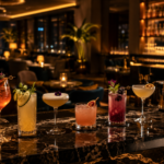 A premium Dubai bar interior with elegant mocktails and cocktails, warm lighting, dark marble, gold accents and a stylish lounge atmosphere.