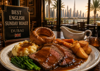 Traditional English Sunday roast with Yorkshire pudding, roast potatoes, vegetables and gravy at a Dubai pub-style restaurant.