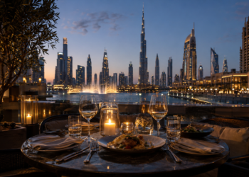 Elegant terrace dining in Downtown Dubai with the Burj Khalifa and Dubai Fountain views at dusk.